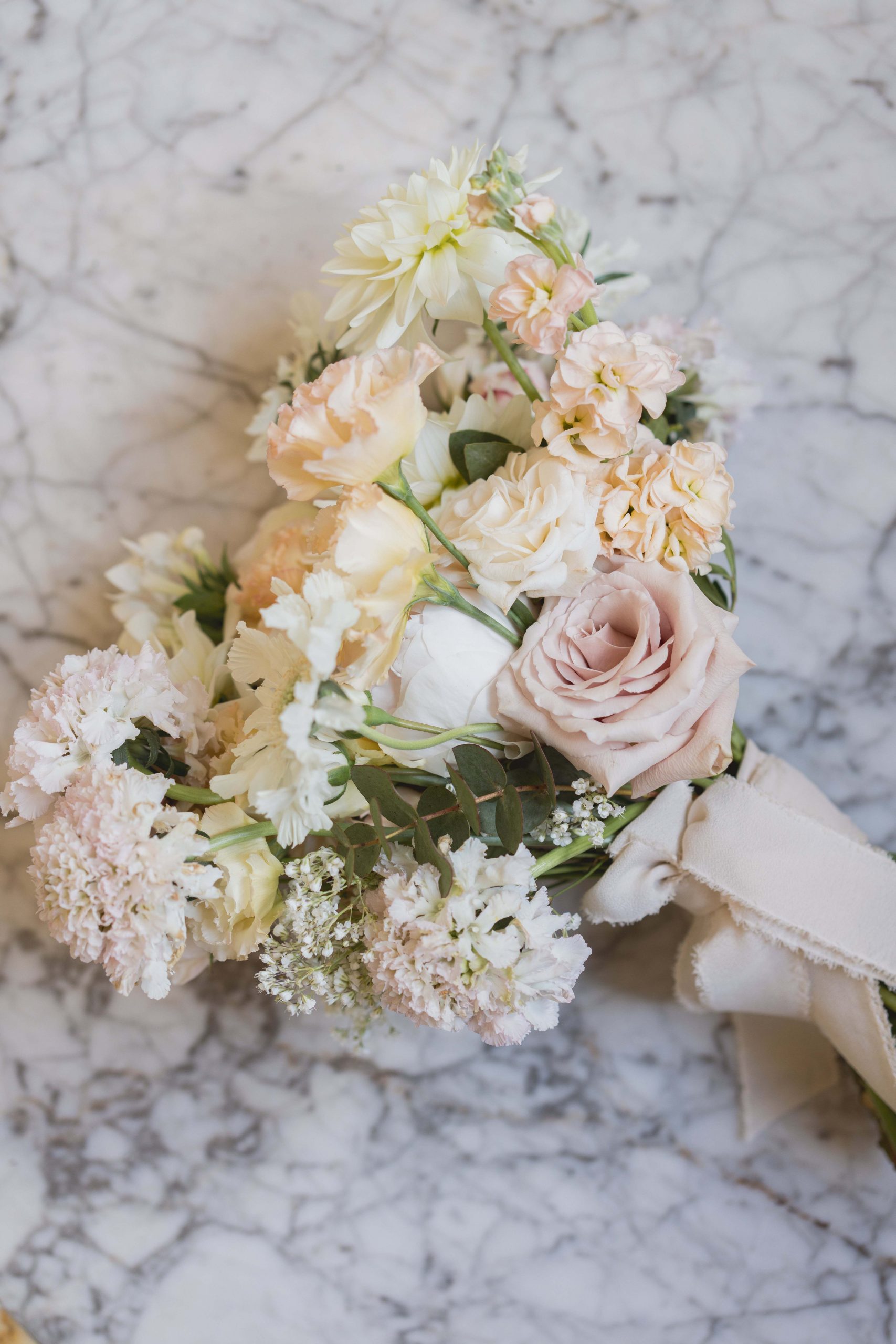 Romantic heart-shaped bouquet with flowers in shades of pink and pale peach